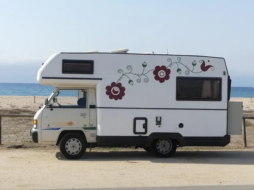 White RV near a body of water