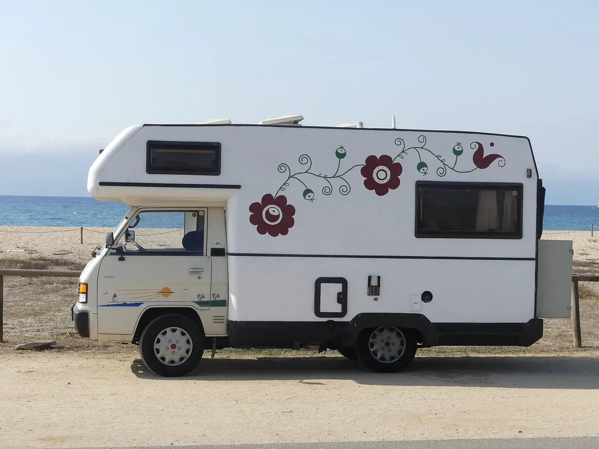 White RV near a body of water